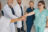 Close up of group of professional medical team of doctors putting their hands together